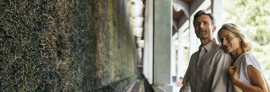 Ein Paar steht vor einer Mooswand und genießt die Sole Luft